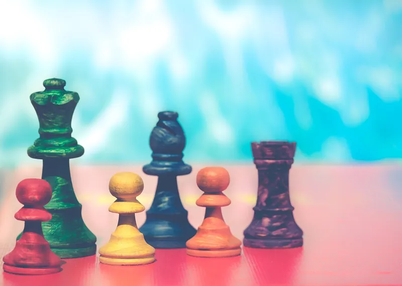 Folding wooden chess board that stores the pieces inside