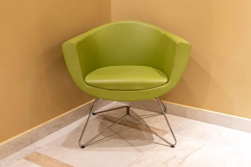 Dark solid-wood colonial armchair with caned back and turned legs, handcrafted in Jodhpur, India