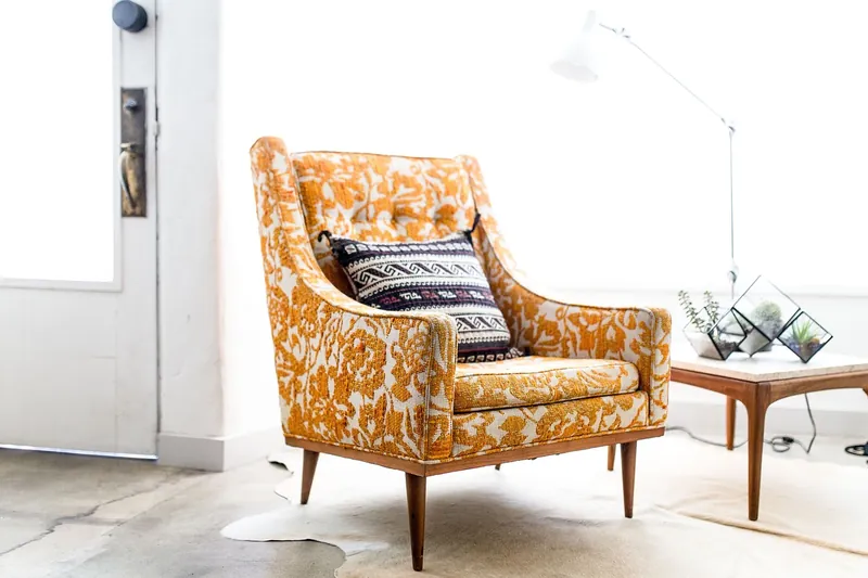 Solid teak armchair with golden-brown grain, handcrafted in Jodhpur, India