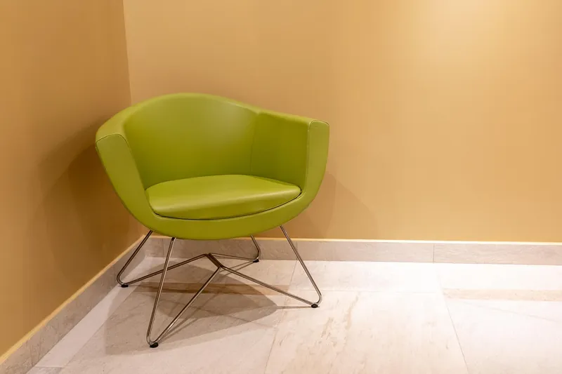 Vintage leather armchair with distressed solid-wood frame, handcrafted in Jodhpur, India
