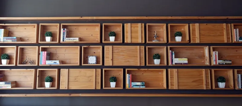 Industrial iron and wood bookshelf with solid timber shelves on a black steel frame, handcrafted in Jodhpur, India