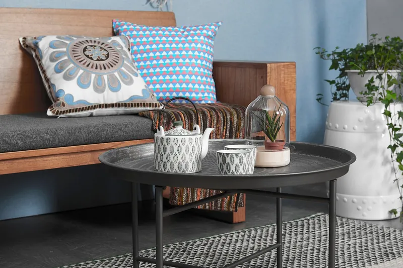 Hand-woven cane coffee table with rattan lower shelf on a solid-wood frame, made in Jodhpur, India