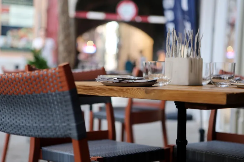 Cross-back farmhouse dining chairs in solid mango wood, handcrafted in Jodhpur, India