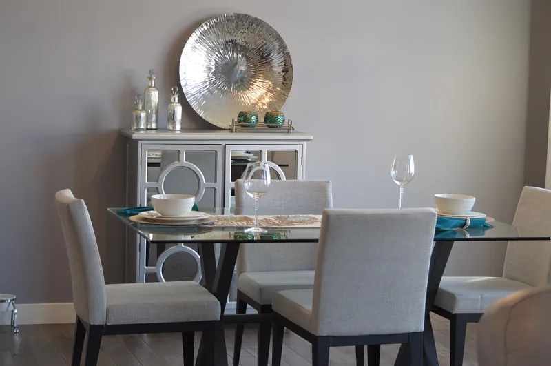 Industrial dining table with a solid reclaimed-wood top on a powder-coated black iron trestle base, handcrafted in Jodhpur, India