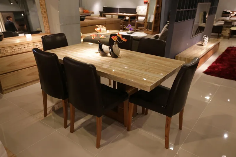Marble top dining table with a sealed veined stone surface on a solid-wood and iron base, handcrafted in Jodhpur, India