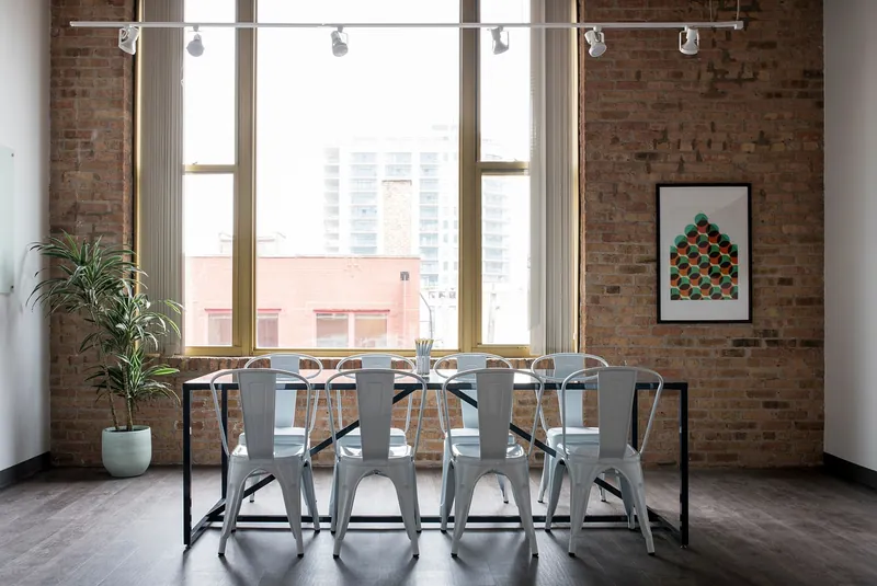 Scandinavian solid-wood dining table with tapered legs and pale matte finish