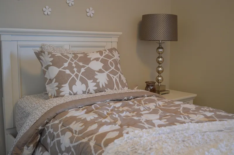 Coastal headboard in whitewashed solid wood with a hand-woven cane panel and slatted edges, handcrafted in Jodhpur, India