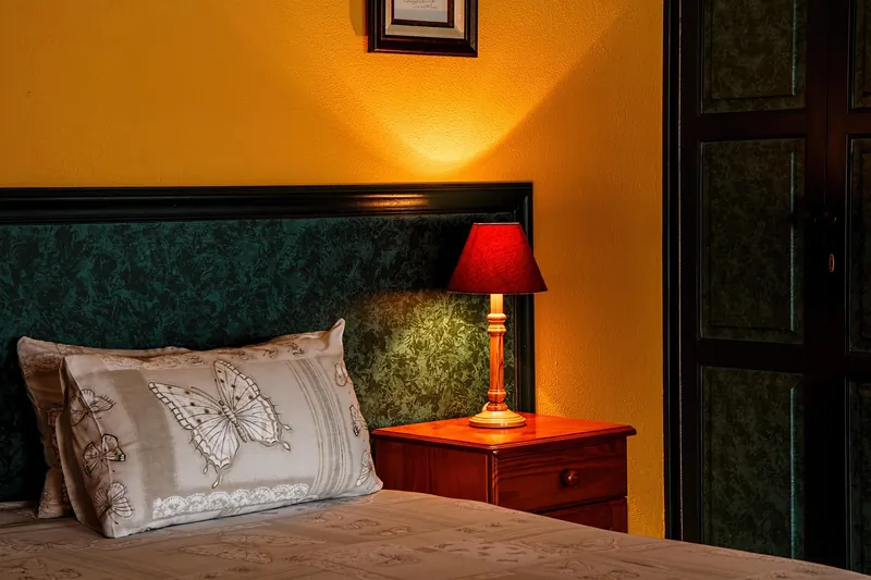 Coastal nightstand with a whitewashed solid-wood carcase and hand-woven cane drawer front, handcrafted in Jodhpur, India
